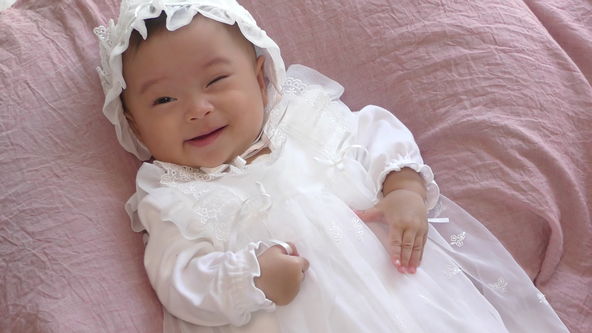 Cute Baby Model Wearing White Baby Dress, Just a moment a wink