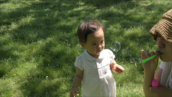 Mom blowing soap bubbles.