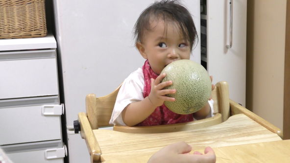 Baby eats whole melon. 1-year-4-month-old baby girl.