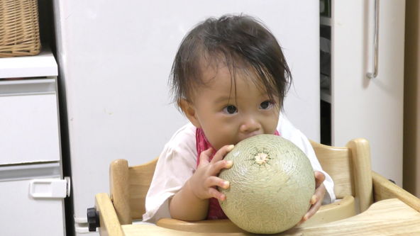Cute and Funny Baby!! This is not a melon bread. It is a real melon.